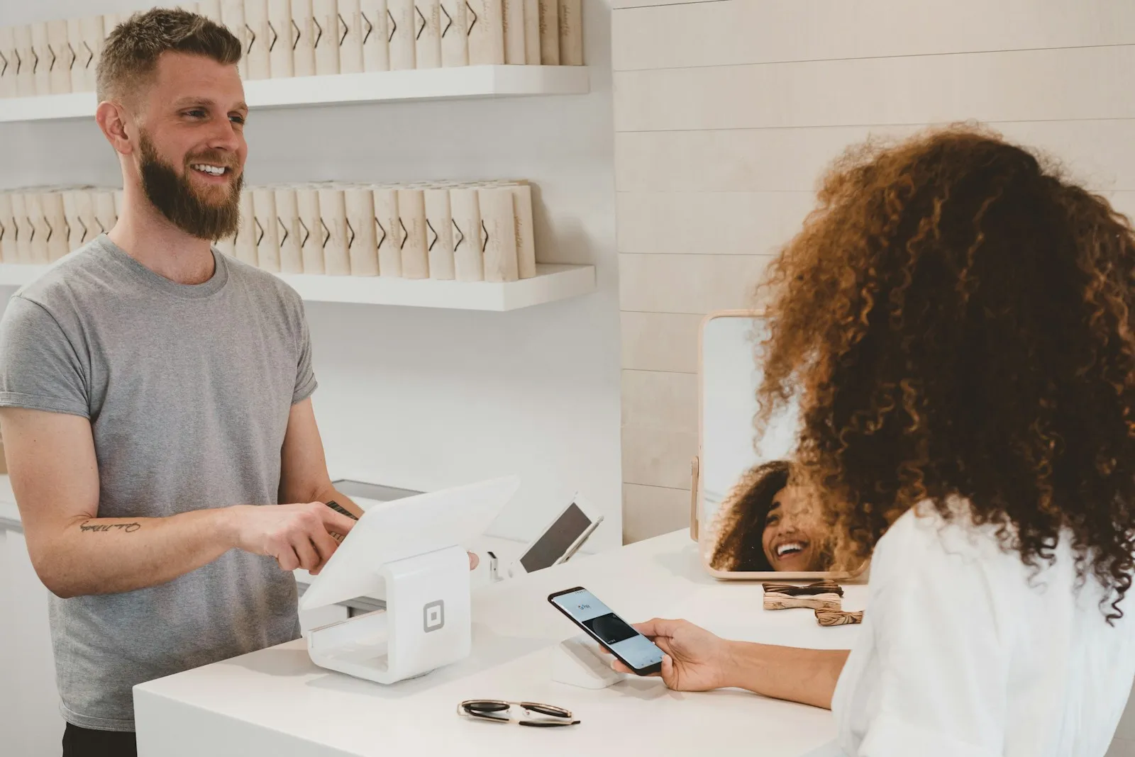 A customer paying for a purchase at a small shop counter